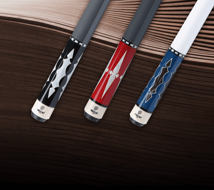 Three pool cues with decorative handles on a wooden surface